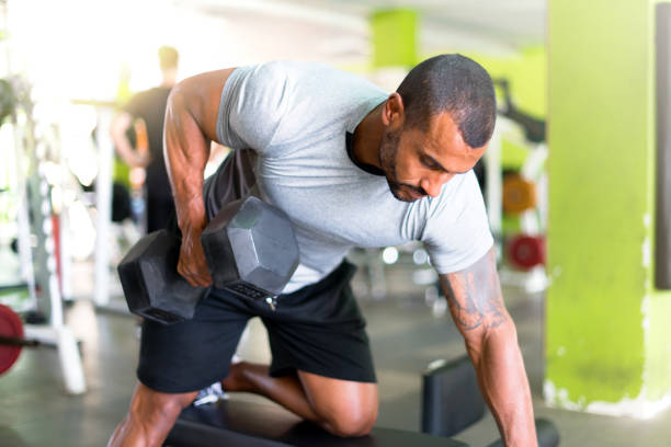 istock Strong handsome sport man making weightlifting in the gym 1188267152