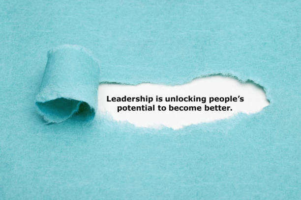 Leadership Is Unlocking Peoples Potential Motivational quote Leadership is unlocking peoples potential to become better appearing behind torn blue paper. foreman stock pictures, royalty-free photos & images