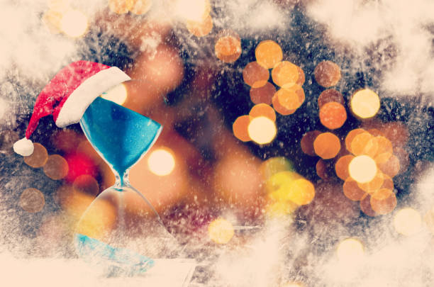 istock Christmas countdown. Modern Hourglass with space for text sand trickling through the bulbs of a crystal sand glass. Holiday themed image. 1188268778