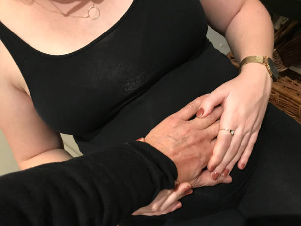 istock Holding hand on pregnant woman 1188269312