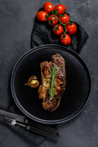 istock Beef sirloin steak on black background.  Marble premium beef 1188271744