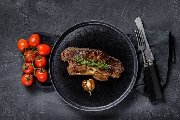 istock Beef sirloin steak on black background.  Marble premium beef 1188271774