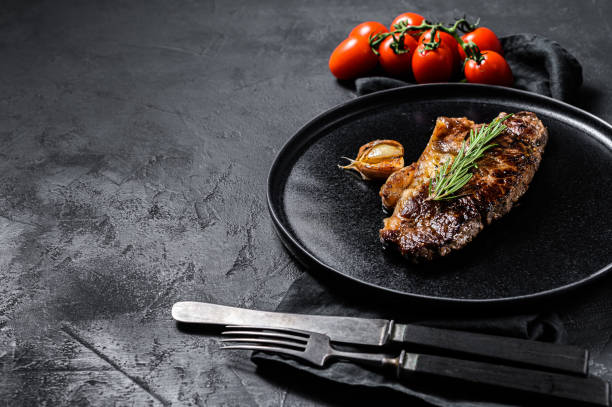 istock Beef sirloin steak on black background. Space for text. Marble beef. 1188271809