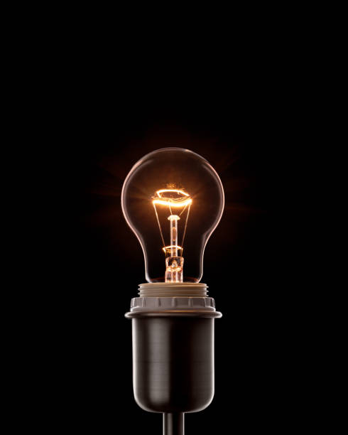 Classic electric lightbulb in the socket. Burning filament stock photo