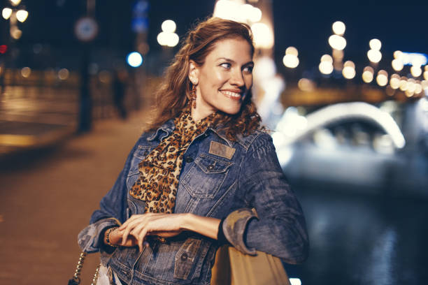 istock Happy young woman smiling and looking away on bridge 1188278005