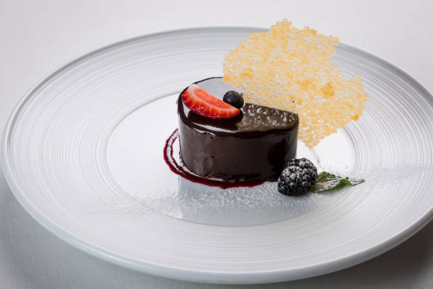 istock Luxury chocolate glazed  dessert with caramel decoration on a white plate 1188278642