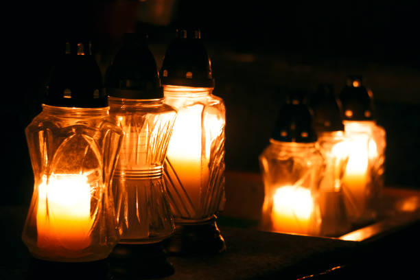 istock Group of burning candles on black background. 1188278766