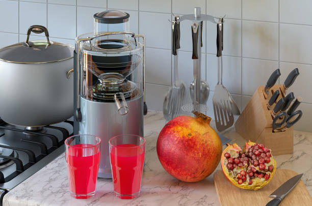Pomegranate juice and electric juicer on kitchen table. 3D rendering