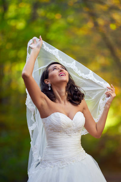 istock Bride in white dress in the forest 1188281265