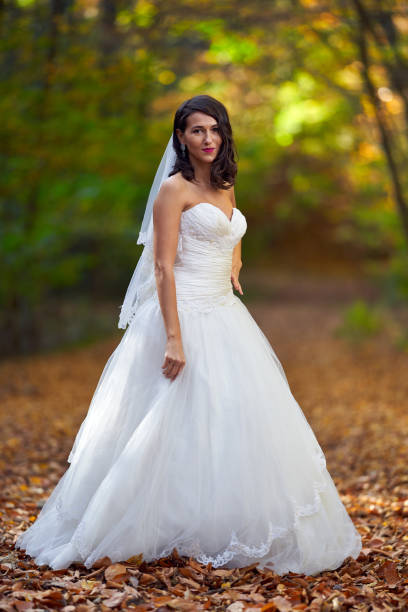 istock Bride in white dress in the forest 1188281272