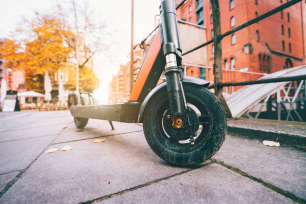 Close up of Electric kick scooter or e-scooter parked on pavement - e-mobility or micro-mobility trend. Speicherstadt, Hamburg, Germany, Europe