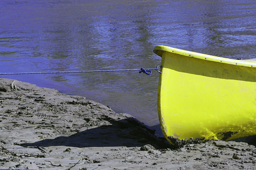 Yellow canoe docked at the coast.