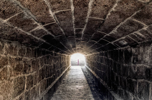 istock Old creepy underground stone tunnel. Halloween Locations 1188283965