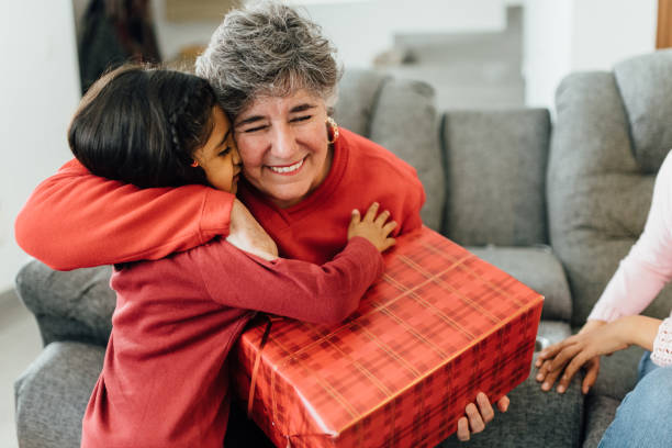 family christmas morning - grandmother giving gift child imagens e fotografias de stock