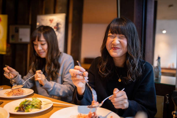 Happy young woman eating lunch at cafe Happy young woman eating lunch at cafe narita japan stock pictures, royalty-free photos & images