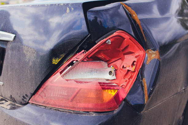istock Smashed Headlight. Close-up of a smashed headlight on a blue car. 1188288104