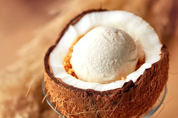 istock Ice cream with nuts and lemon sauce in halved coconut. 1188288892