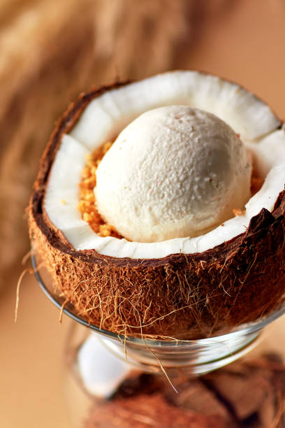 istock Ice cream with nuts and lemon sauce in halved coconut. 1188288899