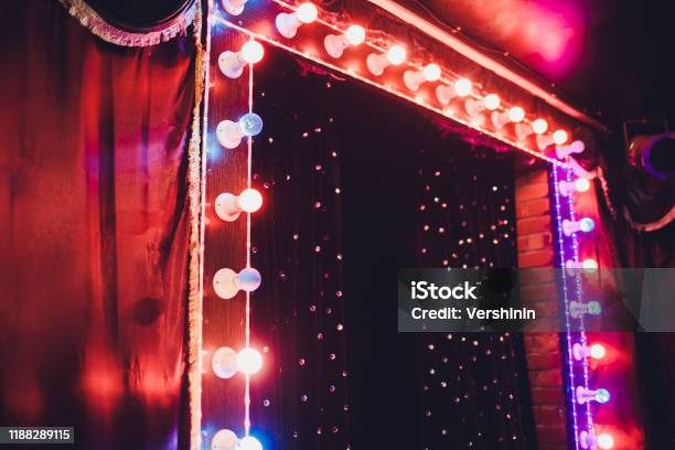 Light Bulbs On Stage Theatrical Scene With Colored Glitter Neon Bulbs For Presentation Or Concert Performance Night Show In Festive Evening Stock Photo - Download Image Now
