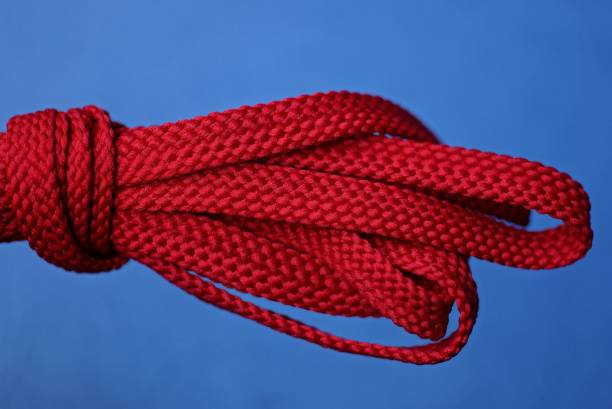 istock red fabric laces on a blue background 1188293979