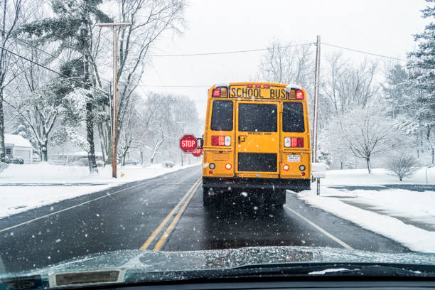 istock Winter Snow Blizzard Car POV Behind Stopped School Bus 1188294735