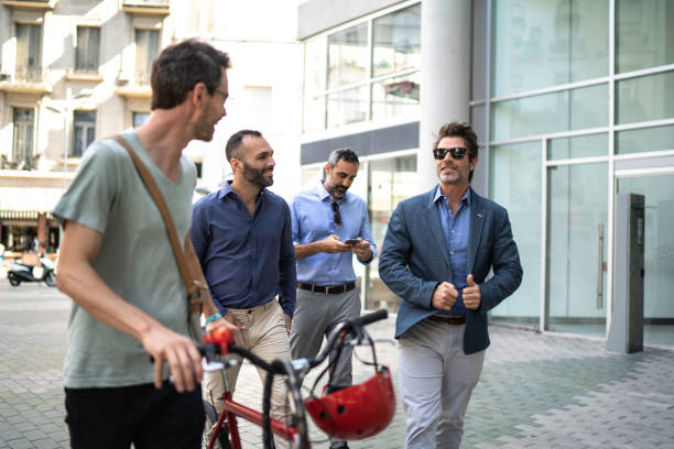 istock Colleagues arriving at work walking and pushing a bike 1188296305