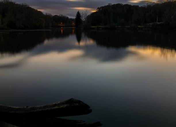 A calm evening on a lake during early spring in New York’s Hudson valley with a colorful sunset afterglow
