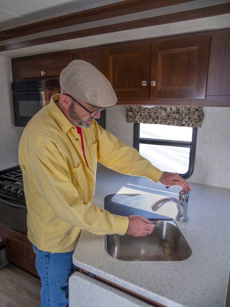 istock Man washing hands in RV sink 1188301652