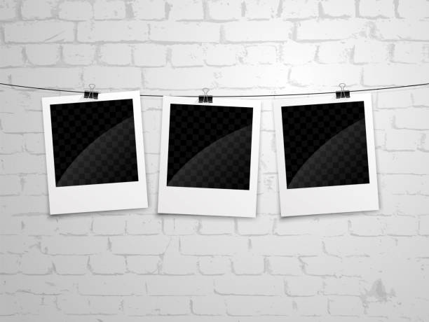 polaroid wall bg polaroid photographs hanging on brick wall background clothesline photos stock illustrations