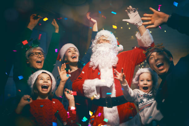 Merry Christmas and Happy Holidays! Grandma, grandpa, mum, dad and children having fun near tree indoors. Family party.