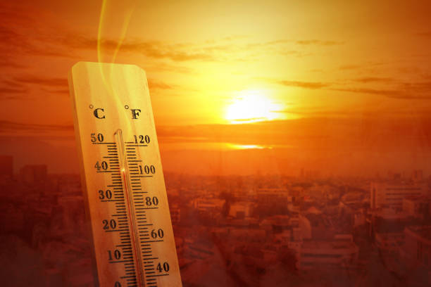 istock Thermometer with high temperature on the city with glowing sun background 1188307021