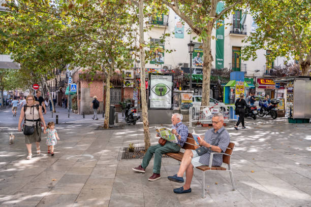 People relax an enjoy the day in the famous Plaza de Santa Ana in central Madrid stock photo