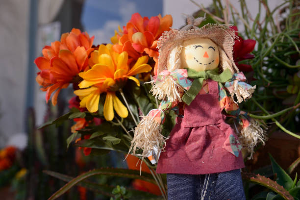 istock Stuffed doll with flowers on display 1188310456