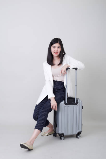 istock woman with luggage Travel on white 1188314647