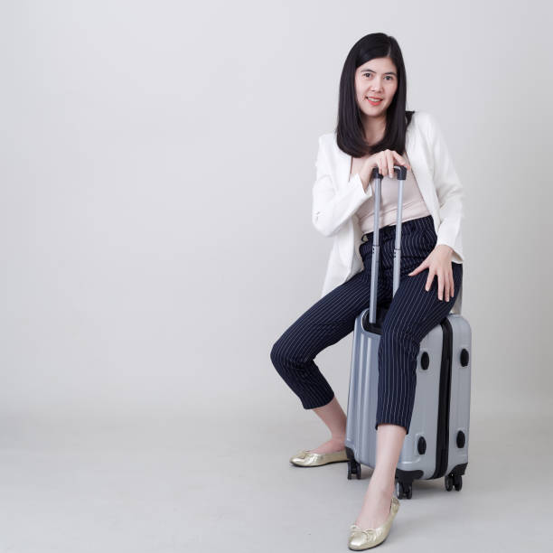 istock woman with luggage Travel on white 1188314662