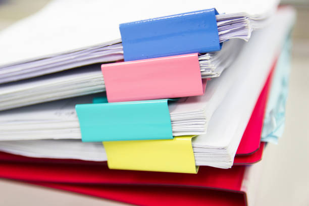 istock file folder and Stack of business report paper file on the table in a work office 1188315751