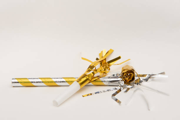 istock Isolated yellow party blowers on white background 1188317969
