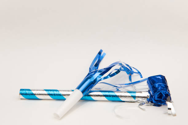 istock Isolated blue party blowers on white background 1188317997