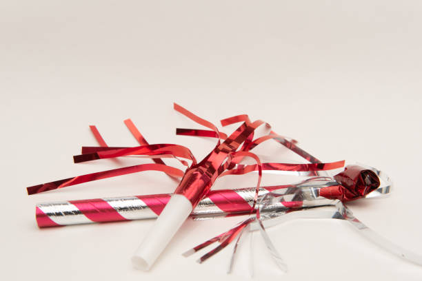 istock Isolated red party blowers on white background 1188318530