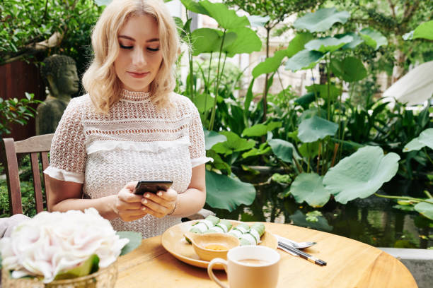 istock Woman texting and eating lunch 1188319665