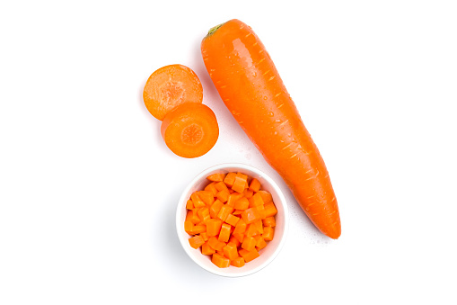 Top view (flat lay) of carrot that was prepared for cooking on white background.