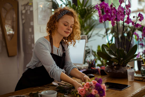 istock Young woman working in a flower shop 1188324606