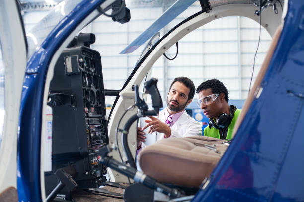 istock Engineer gives the technician instructions on the work to be done to the helicopter 1188324645