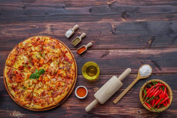 istock Pizza and ingredients on wooden background with copy space. 1188324802