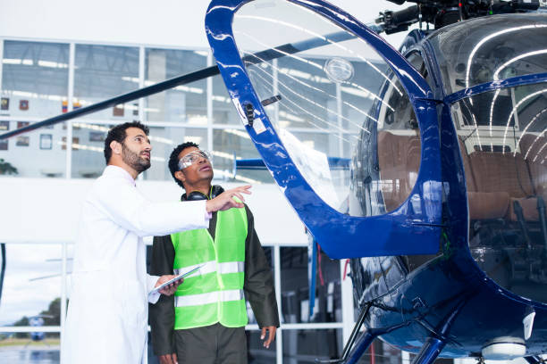 istock Engineer gives the technician instructions on the work to be done to the helicopter 1188325729