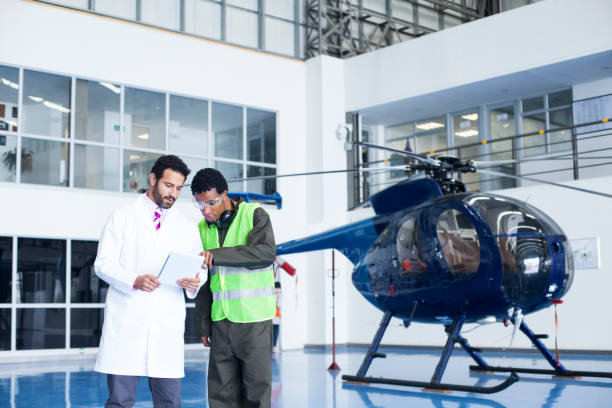 istock Helicopter technicians are in the hangar checking important information from a tablet 1188325894