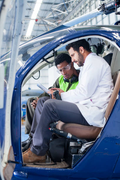 istock Engineer gives the technician instructions on the work to be done to the helicopter 1188325989