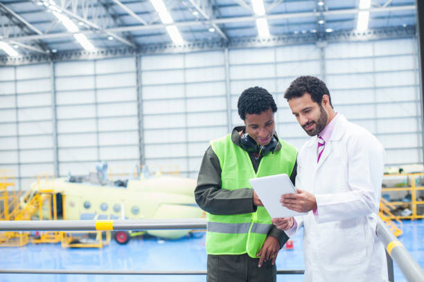 istock Helicopter technicians are in the hangar checking important information from a tablet 1188326104