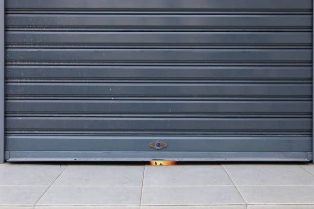 istock black roller shutter door closed security in garage of house 1188327083