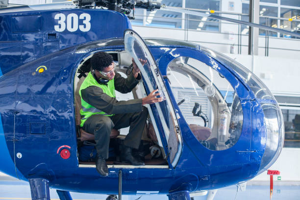 istock Brown-skinned man who is a helicopter technician is checking a helicopter 1188328736
